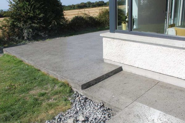 Detail Of Professionally Polished Concrete Patio And Footpath With Steps